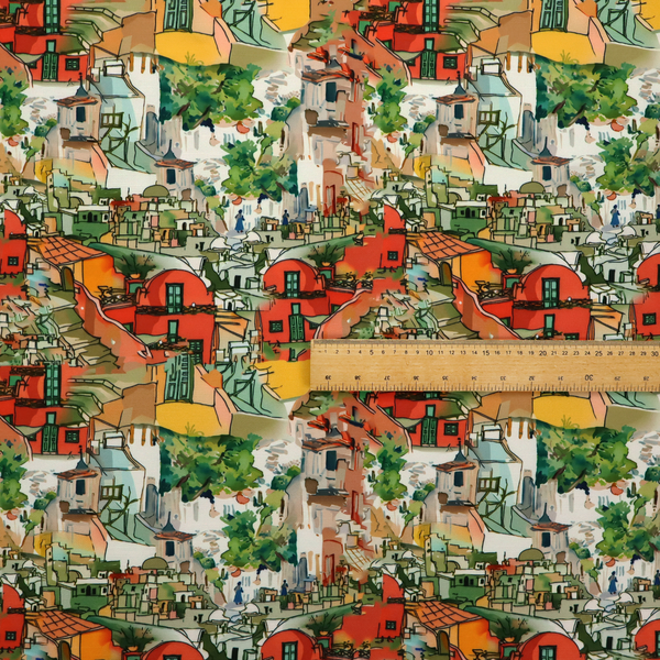 An illustrated fabric pattern featuring a Mediterranean hillside village with terracotta houses, green foliage, and ochre accents