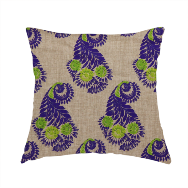 The fabric used to create this handmade cushion is a repeating floral paisley pattern featuring vibrant indigo blue and lime green motifs set against a textured natural beige linen-effect background.