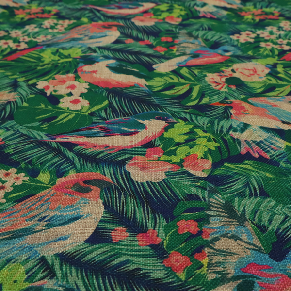 Tropical print fabric featuring colourful birds, palm leaves, and pink flowers against a dark background.