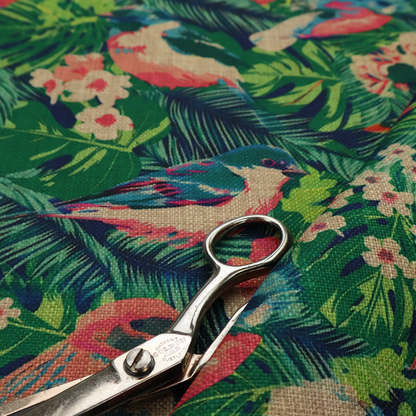 Tropical print fabric featuring colourful birds, palm leaves, and pink flowers against a dark background.