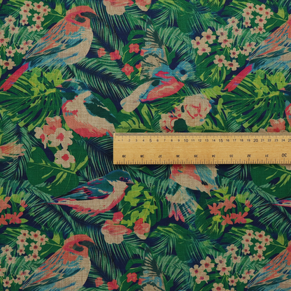 Tropical print fabric featuring colourful birds, palm leaves, and pink flowers against a dark background.