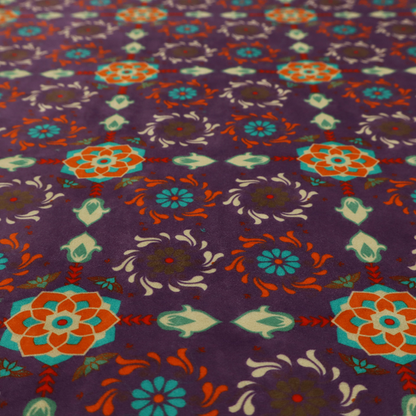 Geometric pattern fabric featuring a purple background with repeating orange and teal mandala-style floral motifs.