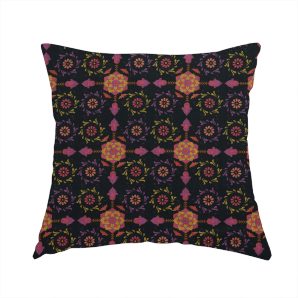 The fabric used to create this handmade cushion is a intricate geometric fabric pattern featuring repeating mandala motifs, floral medallions, and ornate tiles in shades of pink, orange, yellow, and purple set against a dark black background.
