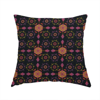 The fabric used to create this handmade cushion is a intricate geometric fabric pattern featuring repeating mandala motifs, floral medallions, and ornate tiles in shades of pink, orange, yellow, and purple set against a dark black background.