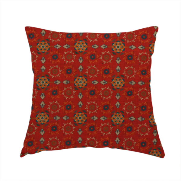 The fabric used to create this handmade cushion is a traditional deep red block-print fabric featuring repeating geometric floral medallions.