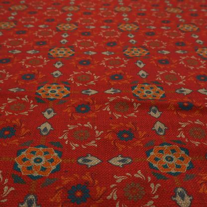 Traditional deep red block-print fabric featuring repeating geometric floral medallions.