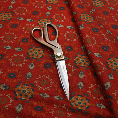 Traditional deep red block-print fabric featuring repeating geometric floral medallions.