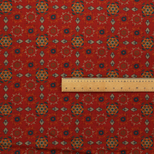 Traditional deep red block-print fabric featuring repeating geometric floral medallions.