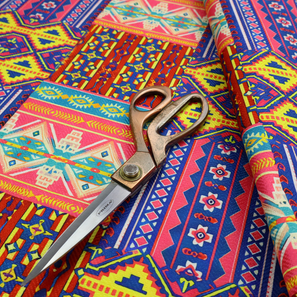 Seamless repeating geometric fabric pattern featuring vibrant tribal and Aztec-inspired patchwork bands in neon yellow, bright pink, cobalt blue, and turquoise.