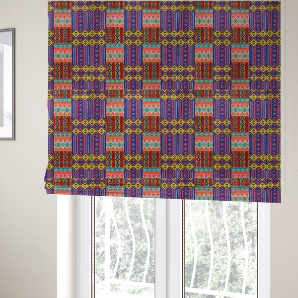 The fabric used to create these Roman blinds is a seamless repeating geometric fabric pattern featuring vibrant tribal and Aztec-inspired patchwork bands in neon yellow, bright pink, cobalt blue, and turquoise.
