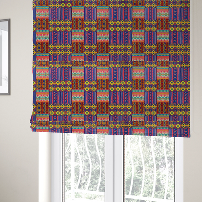 The fabric used to create these Roman blinds is a seamless repeating geometric fabric pattern featuring vibrant tribal and Aztec-inspired patchwork bands in neon yellow, bright pink, cobalt blue, and turquoise.