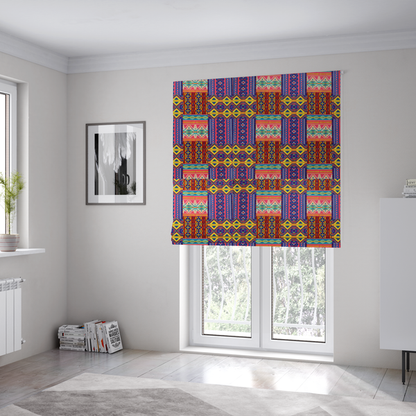 The fabric used to create these Roman blinds is a seamless repeating geometric fabric pattern featuring vibrant tribal and Aztec-inspired patchwork bands in neon yellow, bright pink, cobalt blue, and turquoise.