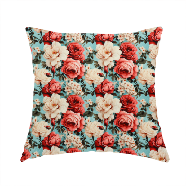 The fabric used to create this handmade cushion is a vintage red, pink, and cream roses print fabric on a duck egg blue background.