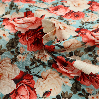 Vintage red, pink, and cream roses print fabric on a duck egg blue background.