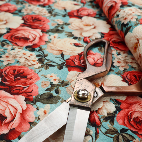 Vintage red, pink, and cream roses print fabric on a duck egg blue background.