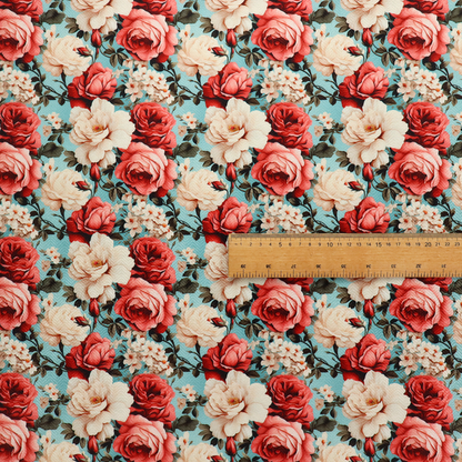 Vintage red, pink, and cream roses print fabric on a duck egg blue background.