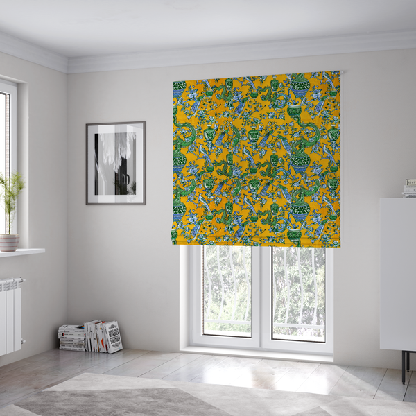 The fabric used to create these Roman blinds is a seamless fabric pattern featuring Chinoiserie-style green dragons, blue and white peacocks, ornate vases, and floral branches against a vibrant mustard yellow background.