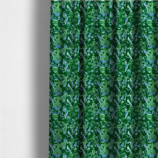 The fabric used to create these made-to-measure curtains is an emerald green fabric featuring a repeating Chinoiserie pattern with light green dragons, blue and white porcelain vases, perched peacocks, and floral branches.   