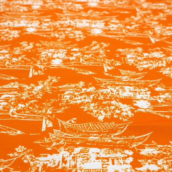Vibrant orange fabric featuring a white Chinoiserie Toile pattern with pagodas, scenic Asian landscapes, and botanical details.   