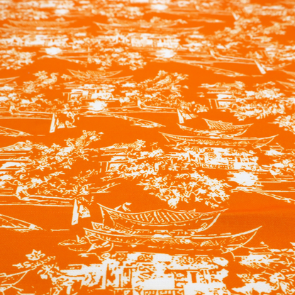 Vibrant orange fabric featuring a white Chinoiserie Toile pattern with pagodas, scenic Asian landscapes, and botanical details.   