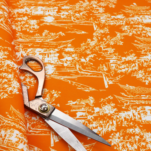Vibrant orange fabric featuring a white Chinoiserie Toile pattern with pagodas, scenic Asian landscapes, and botanical details.   