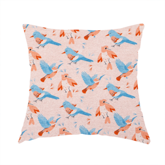 The fabric used to create this cushion includes blue and pink birds in various positions on a soft pink background.
