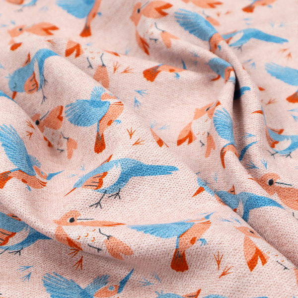 This fabric includes blue and pink birds in various positions on a soft pink background.