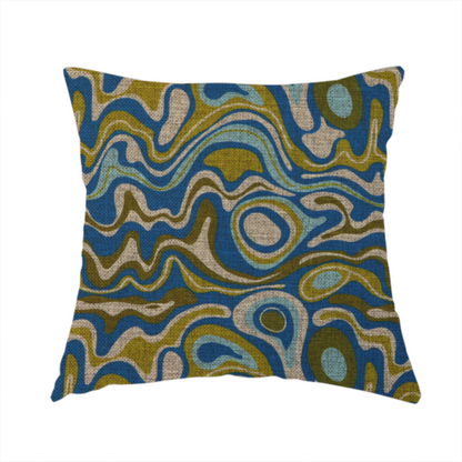 The fabric used to create this handmade cushion, features different shades of green and beige swirls on a blue background.