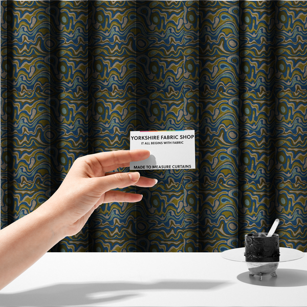 The fabric used to create these made-to-measure curtains, features different shades of green and beige swirls on a blue background.