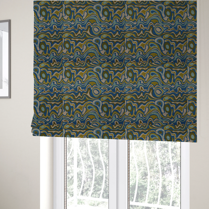The fabric used to create these Roman blinds, features different shades of green and beige swirls on a blue background.