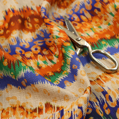 This fabric has a soft chevron pattern, the stripes are made up of blues, greens and oranges, whilst also featuring a leopard pattern.