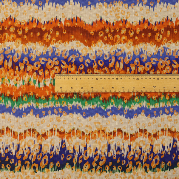This fabric has a soft chevron pattern, the stripes are made up of blues, greens and oranges, whilst also featuring a leopard pattern.