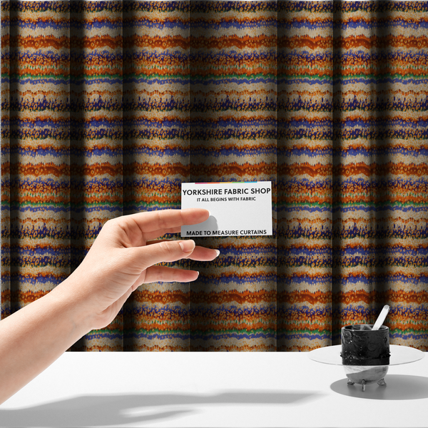 The fabric used to create these made-to-measure curtains has a soft chevron pattern, the stripes are made up of blues, greens and oranges, whilst also featuring a leopard pattern.