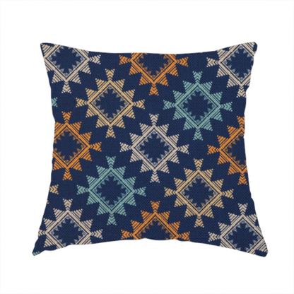 The fabric used to create this handmade cushion features repeated geometric shapes in blues, oranges and pinks on a navy blue background.