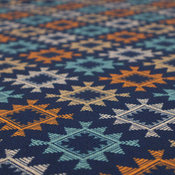 This fabric features repeated geometric shapes in blues, oranges and pinks on a navy blue background.