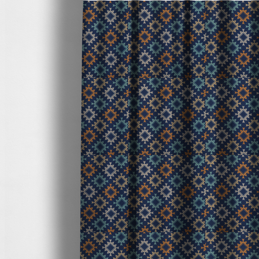The fabric used to create these made-to-measure curtains, features repeated geometric shapes in blues, oranges and pinks on a navy blue background.