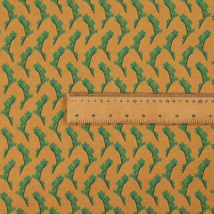 This fabric has a repeated green leaf/floral design on a warm yellow/golden background.
