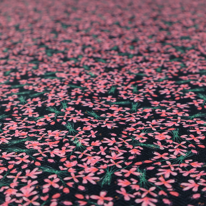This fabric is saturated with pink floral bouquets on a deep green background.