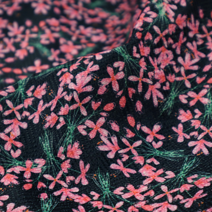 This fabric is saturated with pink floral bouquets on a deep green background.