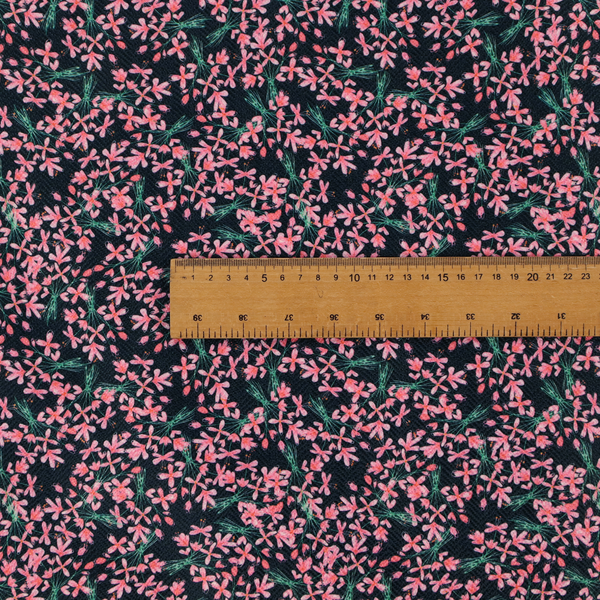 This fabric is saturated with pink floral bouquets on a deep green background.
