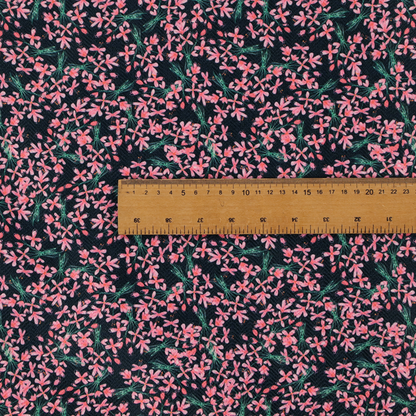 This fabric is saturated with pink floral bouquets on a deep green background.