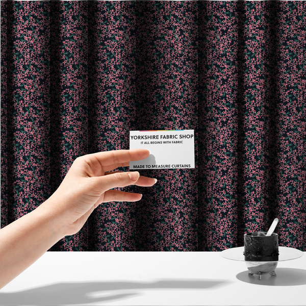 The fabric used to create these made-to-measure curtains is saturated with pink floral bouquets on a deep green background.