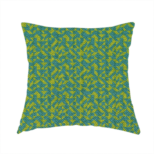 The fabric used to create this handmade cushion has a small, repeated geometric pattern in lime green and blue.
