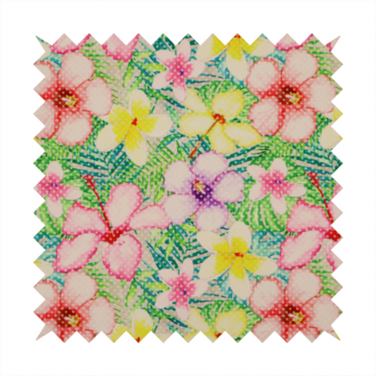 A vibrant tropical fabric pattern featuring pink and purple hibiscus flowers, yellow plumeria, and green palm leaves on a light grey dotted background.