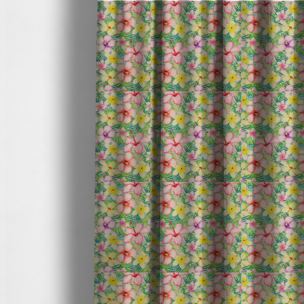 The fabric used to create these made-to-measure curtains is a vibrant tropical fabric pattern featuring pink and purple hibiscus flowers, yellow plumeria, and green palm leaves on a light grey dotted background.