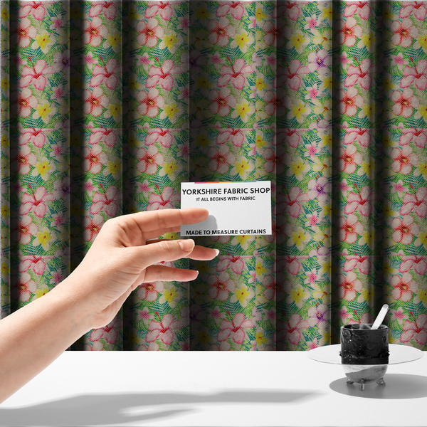 The fabric used to create these made-to-measure curtains is a vibrant tropical fabric pattern featuring pink and purple hibiscus flowers, yellow plumeria, and green palm leaves on a light grey dotted background.