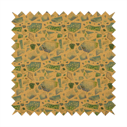 An earthy, abstract fabric pattern featuring organic mosaic shapes in moss green, teal, and slate grey on a textured mustard yellow background.