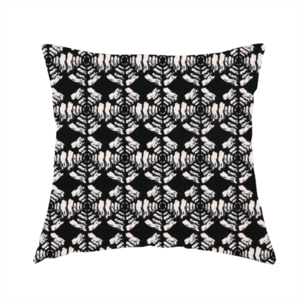 The fabric used to create this handmade cushion is a bold, monochrome fabric pattern featuring a repeating hand-inked radial geometric design in cream on a solid black background.