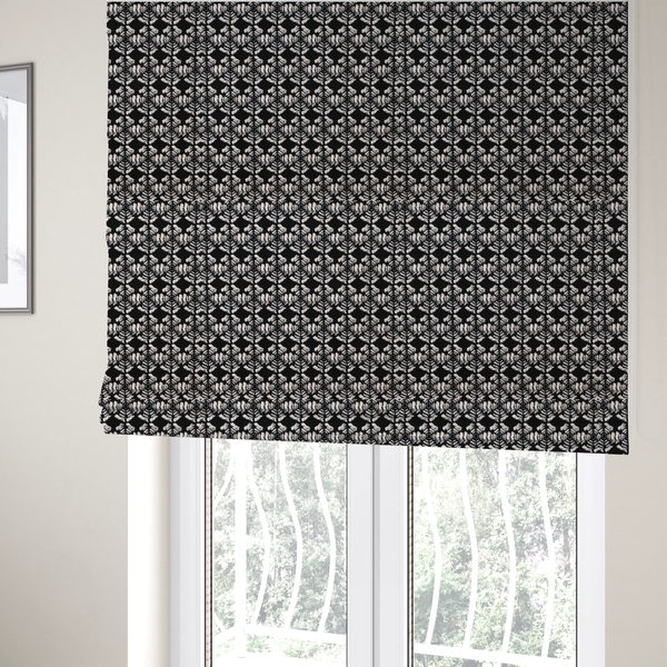 The fabric used to create these bespoke Roman blinds is a bold, monochrome fabric pattern featuring a repeating hand-inked radial geometric design in cream on a solid black background.