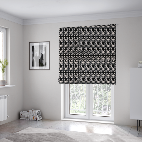 The fabric used to create these bespoke Roman blinds is a bold, monochrome fabric pattern featuring a repeating hand-inked radial geometric design in cream on a solid black background.